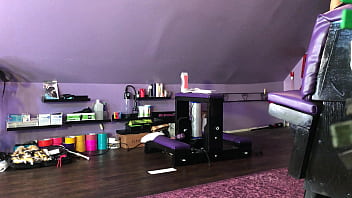 Dominatrix waxing man;s legs