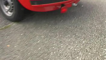 Bimba siting barefoot in her volkswagen car revving the engine