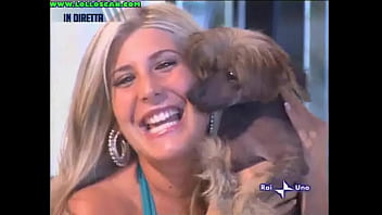 Live television panty oops upskirt as a hottie picks up a dog and leaves her underwear on display