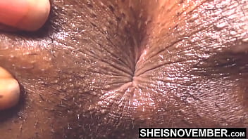 My winking asshole and booty cheeks spreading in slow motion with wet pussy exposed petite hot ebony slut sheisnovember lays nude on her couch with sexy legs wiggling with anus pulled open while arching her back closeup on msnovember