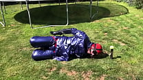 Hogtied in rain wear, rubber rain boots, hand cuffed inside ladies knee high boots