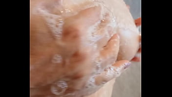 Sexy mature lathers her nipples in the shower