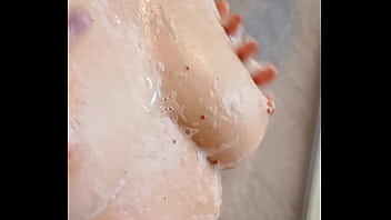 Sexy mature lathers her nipples in the shower