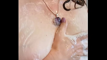 Sexy mature lathers her nipples in the shower