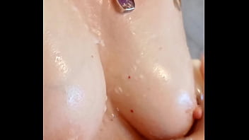 Sexy mature lathers her nipples in the shower