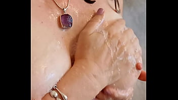 Sexy mature lathers her nipples in the shower