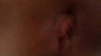 Young busty brunette teases clit with toys on