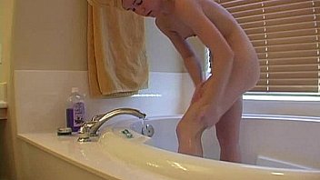Girl shaving her legs in home movie