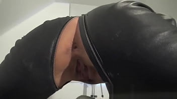 Brunette in leather catsuit masturbating to orgasm