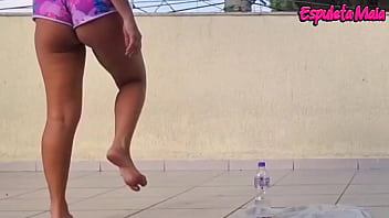 Brunette training outdoors with her shorts tucked up her ass