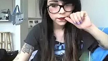 Emo looking girl in big specs in t shirt and tiny panties and socks