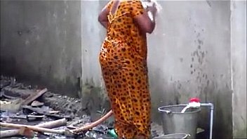 Indian couple bathing out side