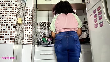 Curvy girl farting in jeans while doing the dishes