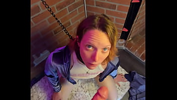 Chained to the wall and on her knees ready to suck