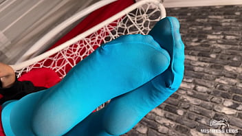 Long sexy legsand feet in blue nylons swings in a hanging chair above you