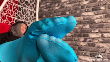 Long sexy legsand feet in blue nylons swings in a hanging chair above you