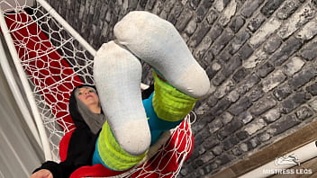 Long sexy legsand feet in blue nylons swings in a hanging chair above you