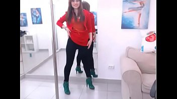 Riley removes top dances around pole in tight pants and heels