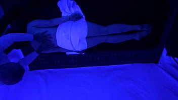 Horny naked slut gets massage under black light Horny naked slut gets massage under black light