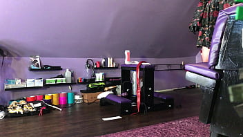 Dominatrix waxing man;s legs