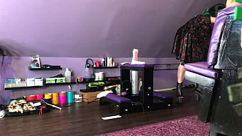 Dominatrix waxing man;s legs