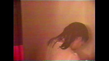 Busty brunette gets soaked in the shower