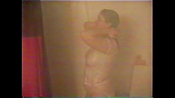 Busty brunette gets soaked in the shower