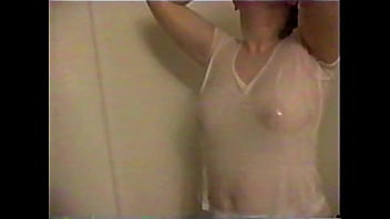 Busty brunette gets soaked in the shower