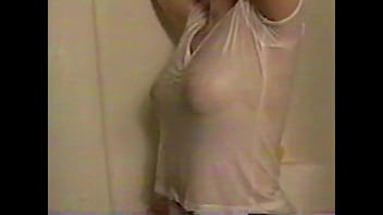 Busty brunette gets soaked in the shower