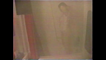 Busty brunette gets soaked in the shower