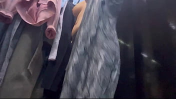 A woman undresses in a public dressing room