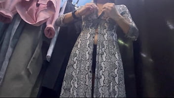 A woman undresses in a public dressing room