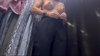 A woman undresses in a public dressing room