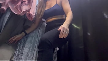 A woman undresses in a public dressing room