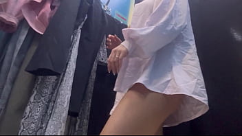 A woman undresses in a public dressing room