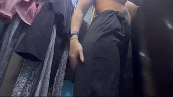 A woman undresses in a public dressing room