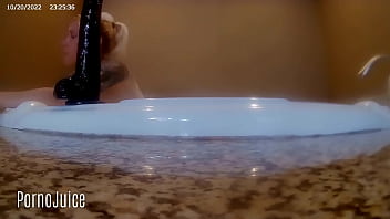 Petite blonde plays with huge bbc toy in the bath