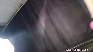 Squirting lesbians toy during enema session