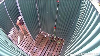 Brunette milf showering in public pool