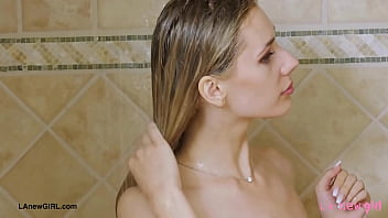 Aspiring blonde model enjoys a sensual bath