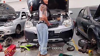 A colombian woman working as a car mechanic seduces a porn actor to have sex in the workshop
