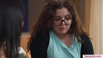 Chubby nerd and her brunette stepsister are on the bed kissing each other passionately