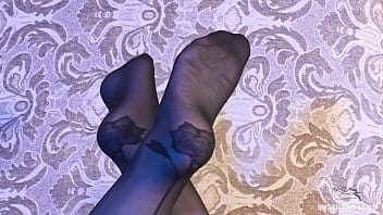 Enjoy my feet in sexy black nylons with flower prints on my heels