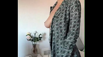 The beauty got excited while calling a friend and started masturbating with her fingers