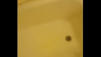 Urinating unto the bathtub