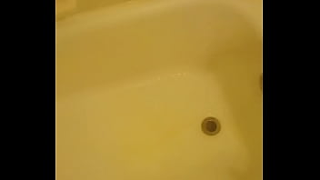 Urinating unto the bathtub