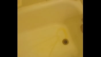 Urinating unto the bathtub