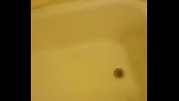Urinating unto the bathtub