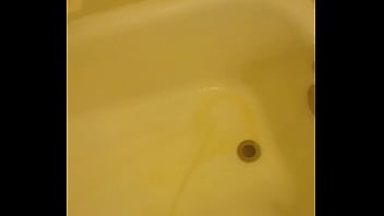 Urinating unto the bathtub
