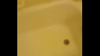 Urinating unto the bathtub